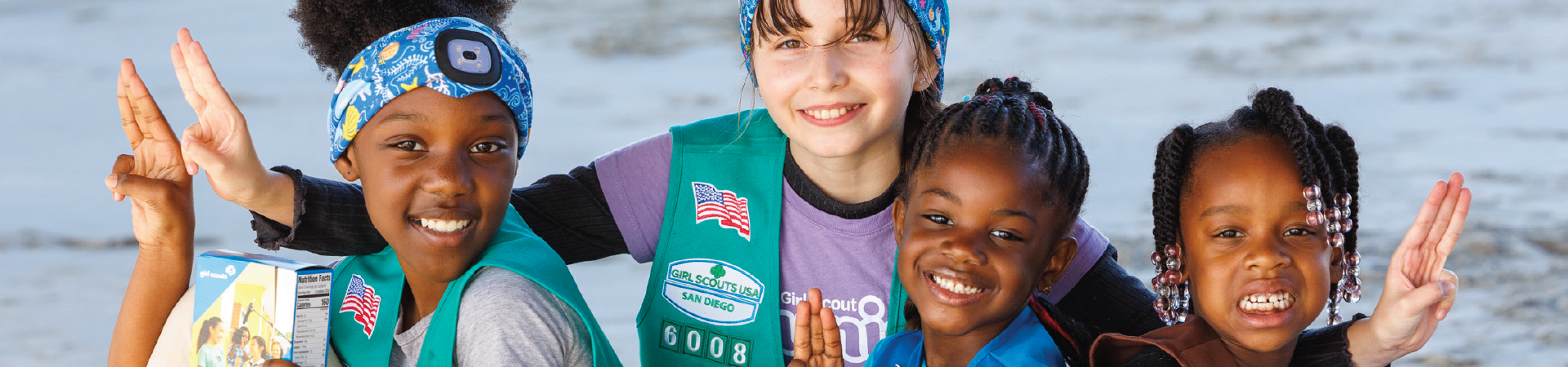  Two daisy Girl Scouts holding lantern in tent wearing trefoil shirt 