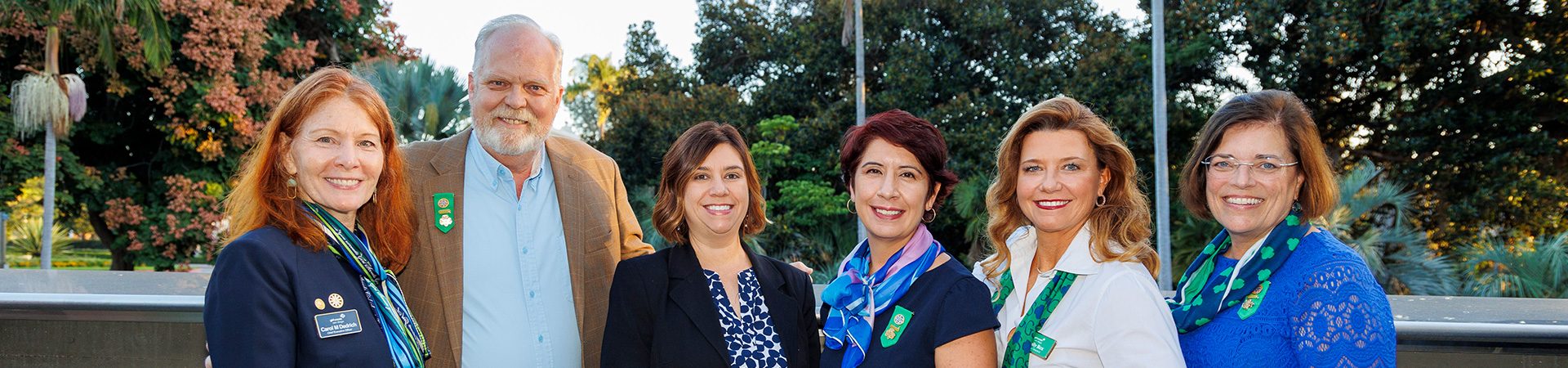  girl scout staff or volunteer wearing adult vest in woods smiling 