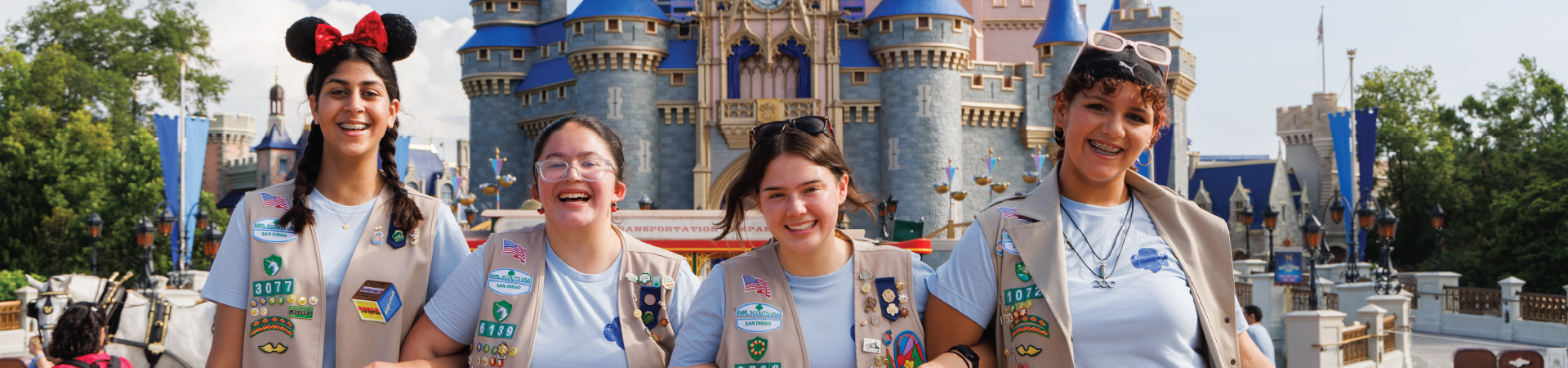  girl scout volunteer parent with young girl hiking outside at state park 