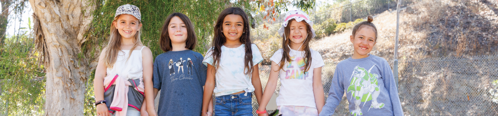  Group of Junior Girl Scouts smiling and laughing outdoors 