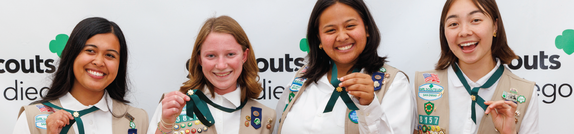  girl scout ambassador high school girl in school wearing sash with highest awards pins 