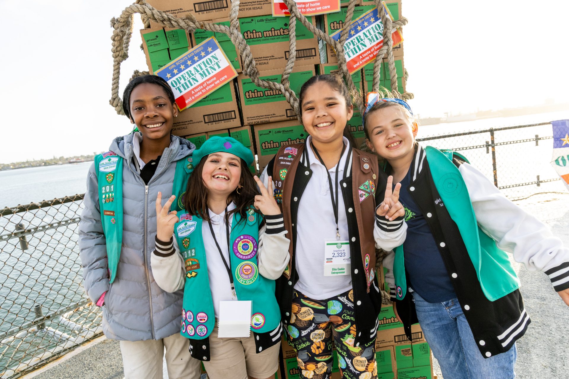 girl scouts smiling wearing junior and brownie uniforms at operation thin mint